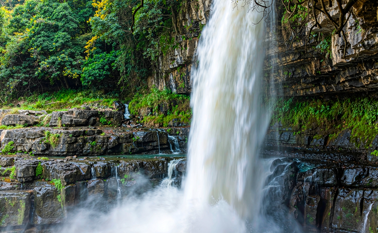 Munigou travertine pools at Zhaga Waterfall cascading over limestone terraces in Sichuan