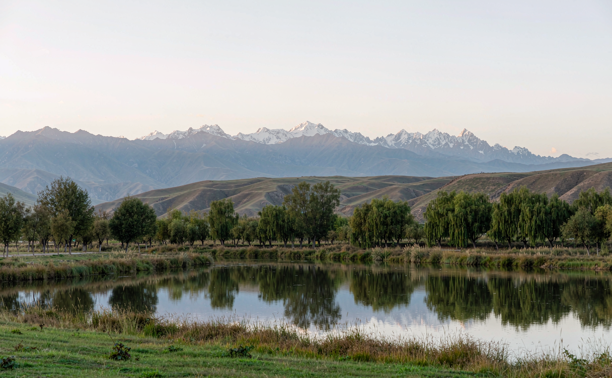 Napahai lake Shangri-La reflecting snow mountains in Yunnan