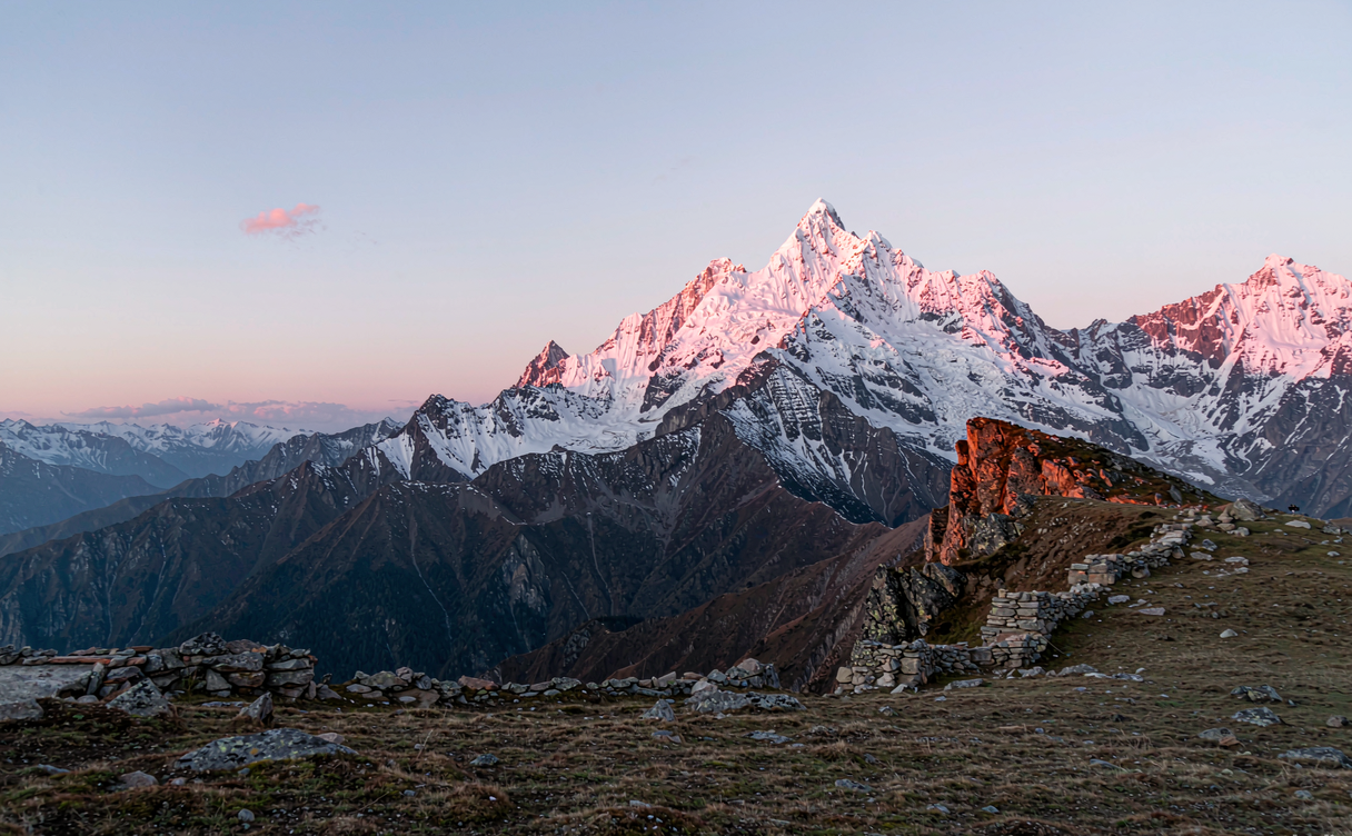 Niubei Mountain sunrise viewpoint with Gongga snow range glowing pink over cloud sea