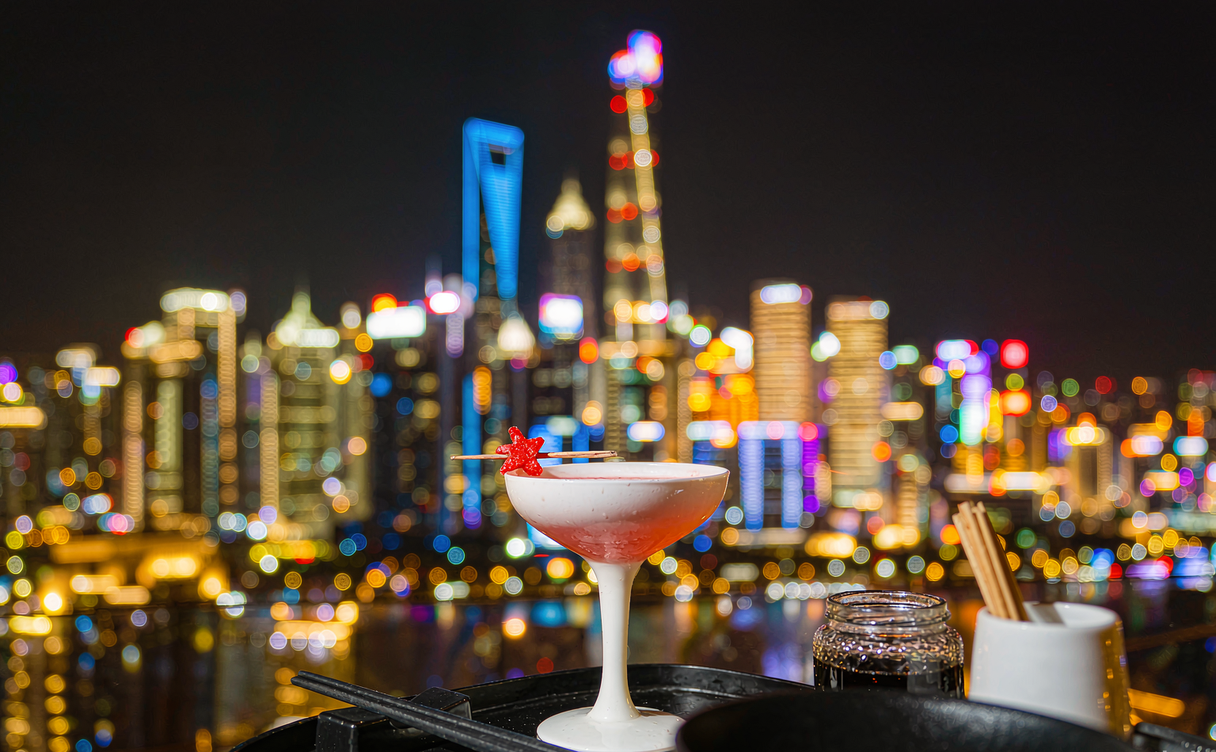 Night view from a Pudong rooftop bar over the Huangpu River in Shanghai