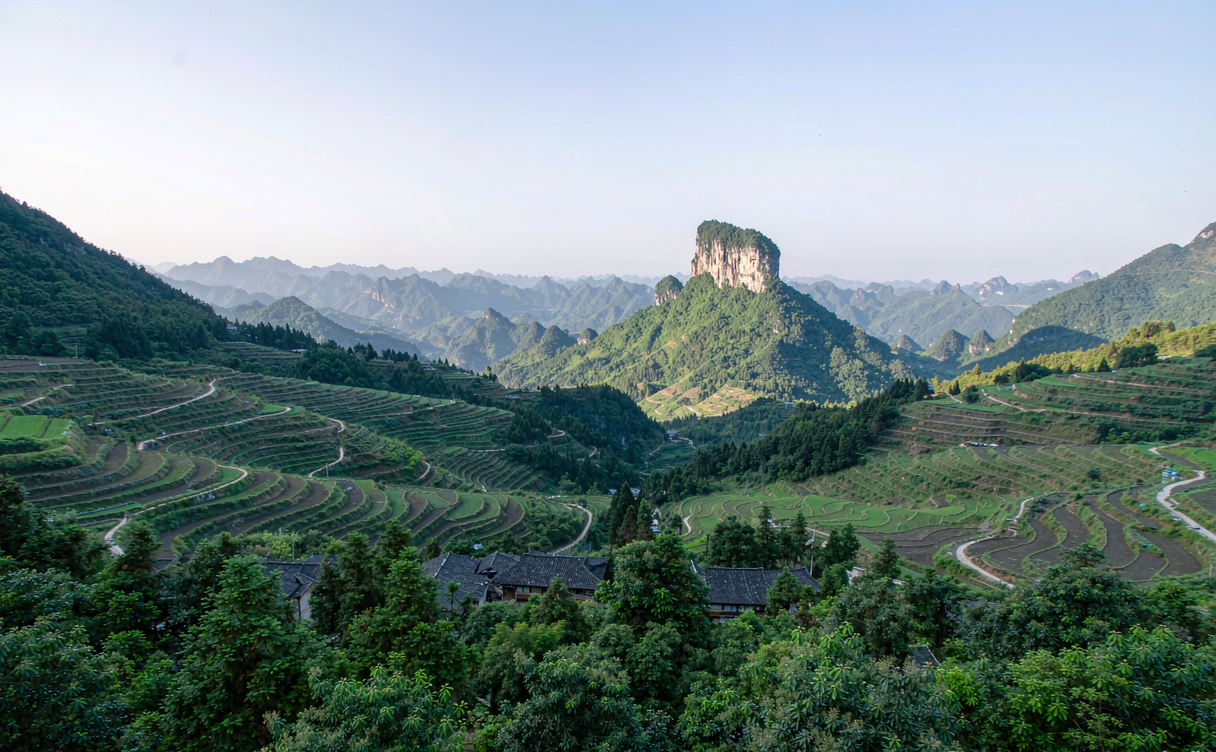 The clear green Qiupu River winding through misted limestone hills in Shitai, Anhui, China