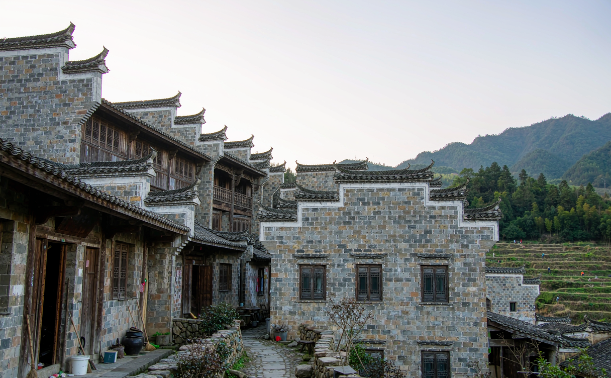 Arched stone bridge spanning a green stream in Songzhuang village, Songyang