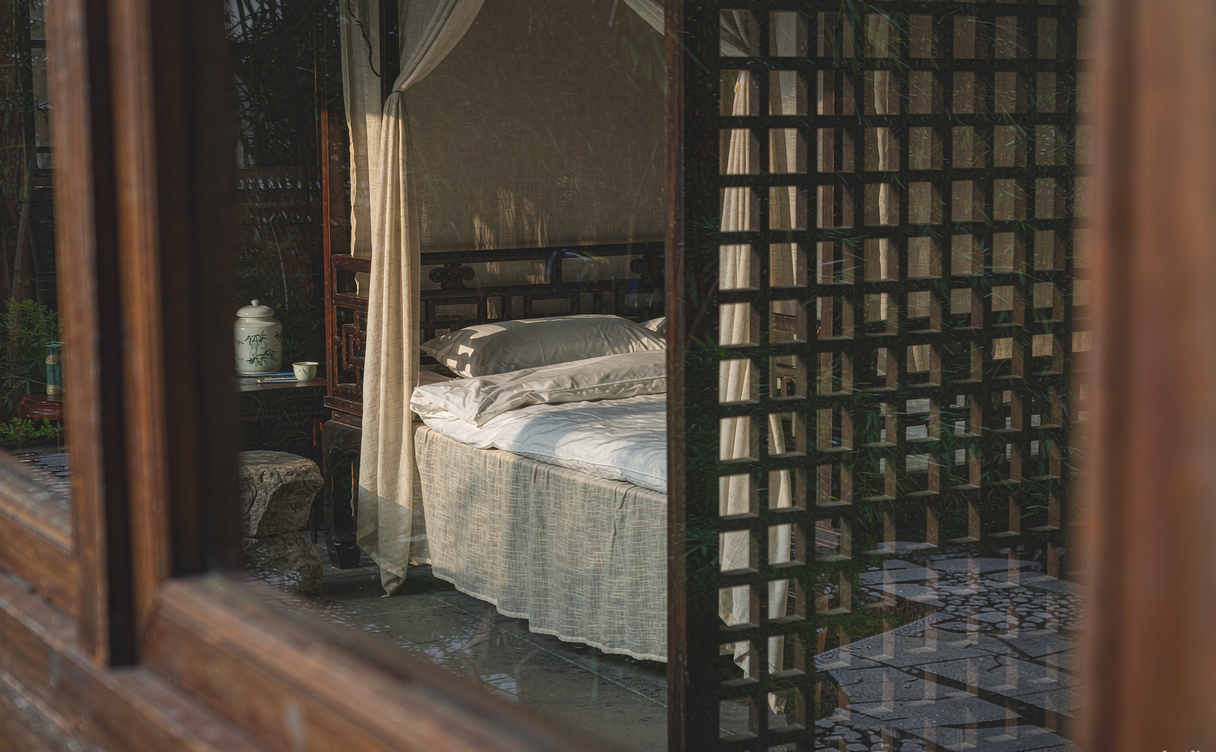 Courtyard garden with moon-gate and koi pond at a Suzhou heritage hotel