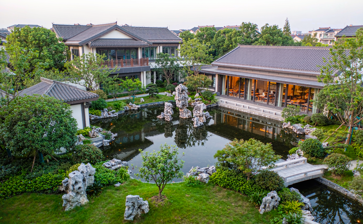 Lattice window framing rockery and pond inside a Suzhou garden hotel