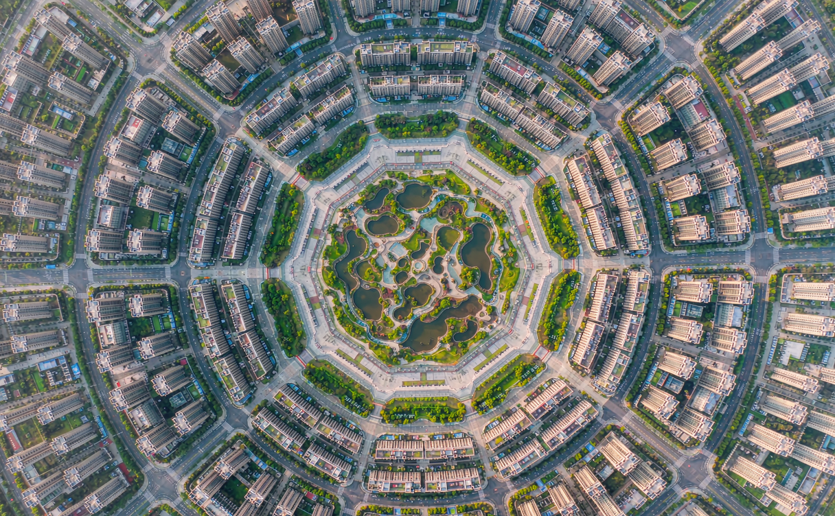 Overhead view of Tekes eight-trigram city layout with radial roads and a central park