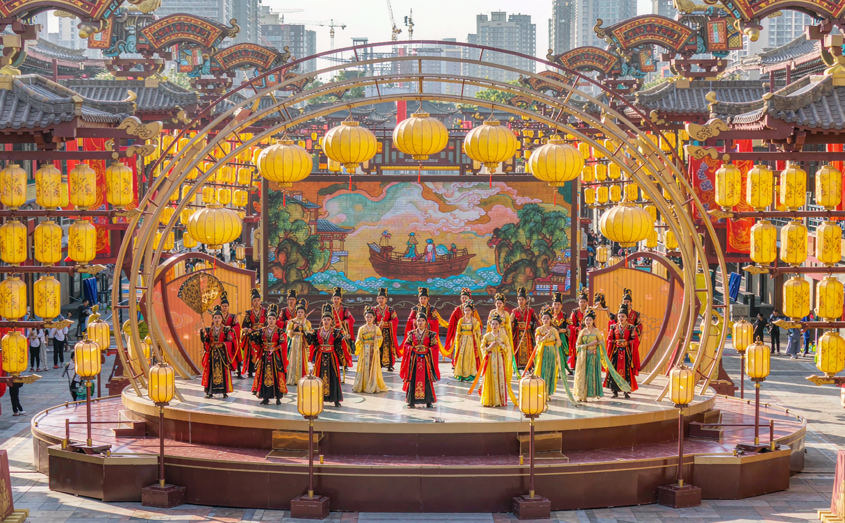Performers in Tang dynasty costume posing on a lantern-lit stage at Datang Everbright City in Xian, Shaanxi, China