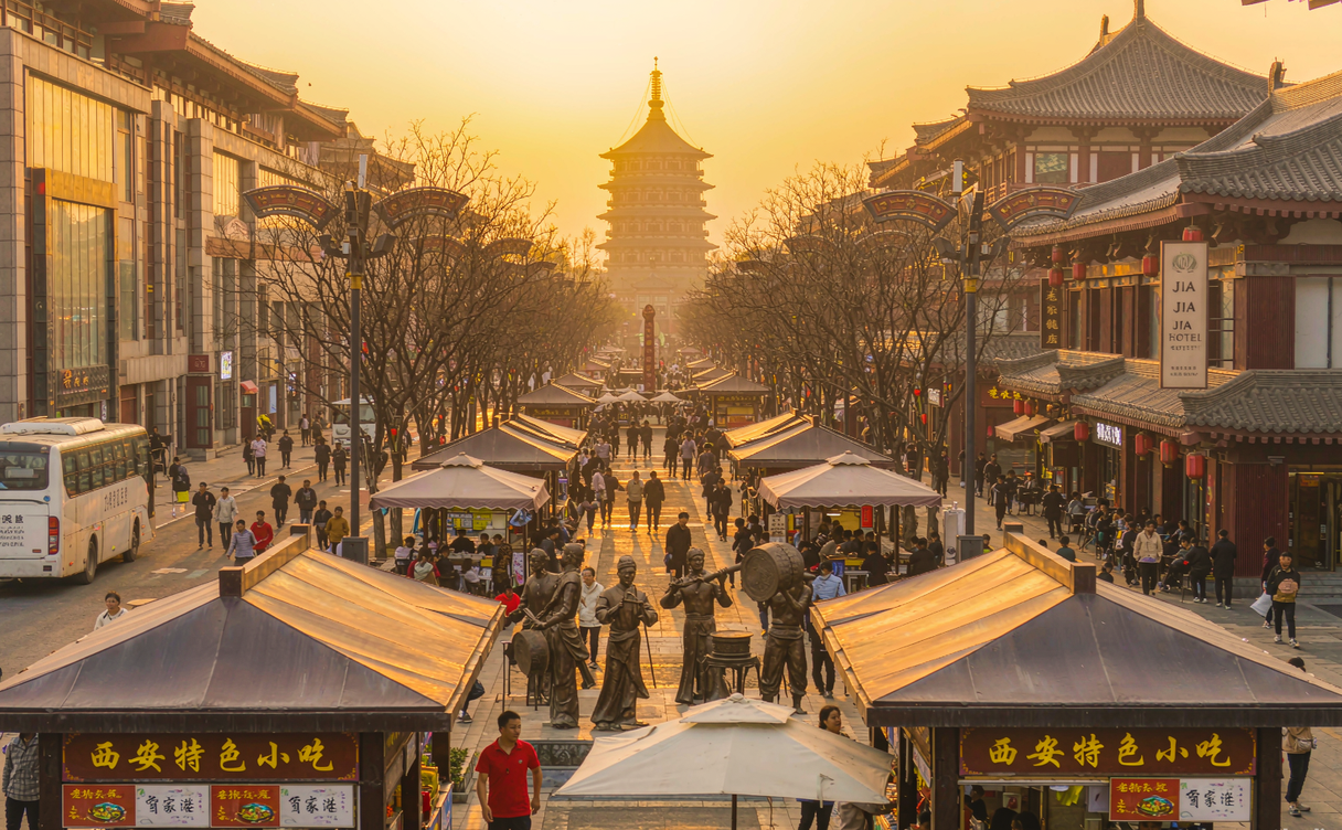 Illuminated Tang-style pavilions and evening crowds along the Datang Everbright City promenade in Xi'an, Shaanxi, China