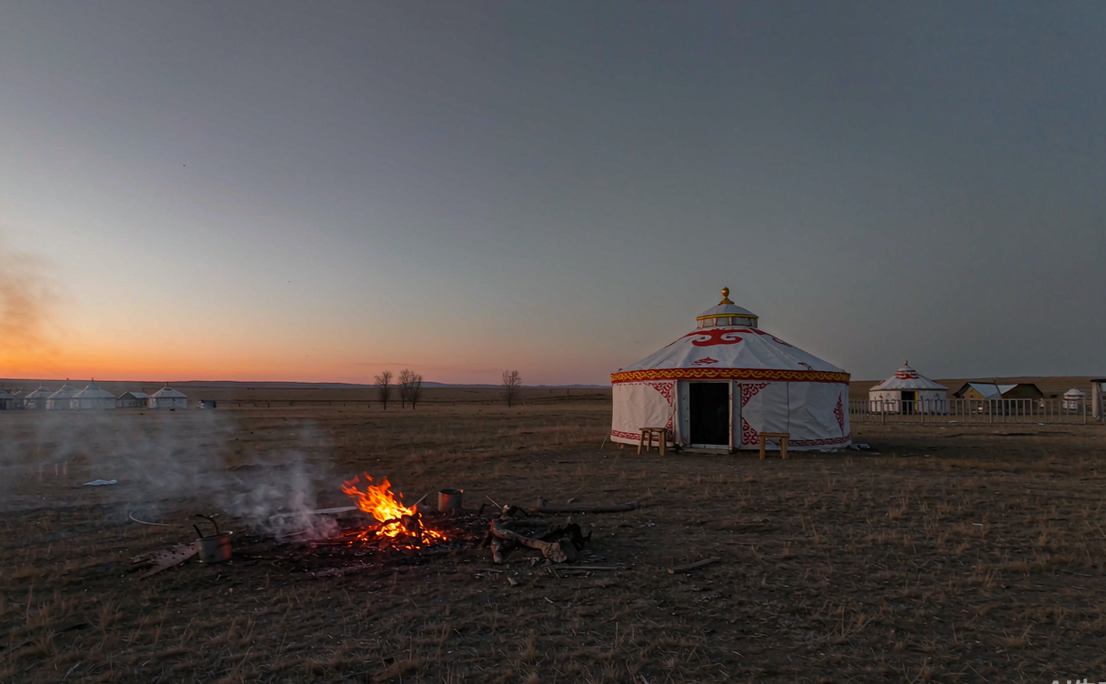 Yurt camp with campfire at dusk on Xilingol grassland Inner Mongolia China