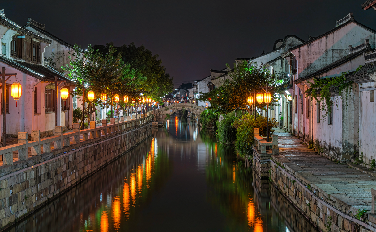 Empty stone bridge over a misty Xitang canal at dawn