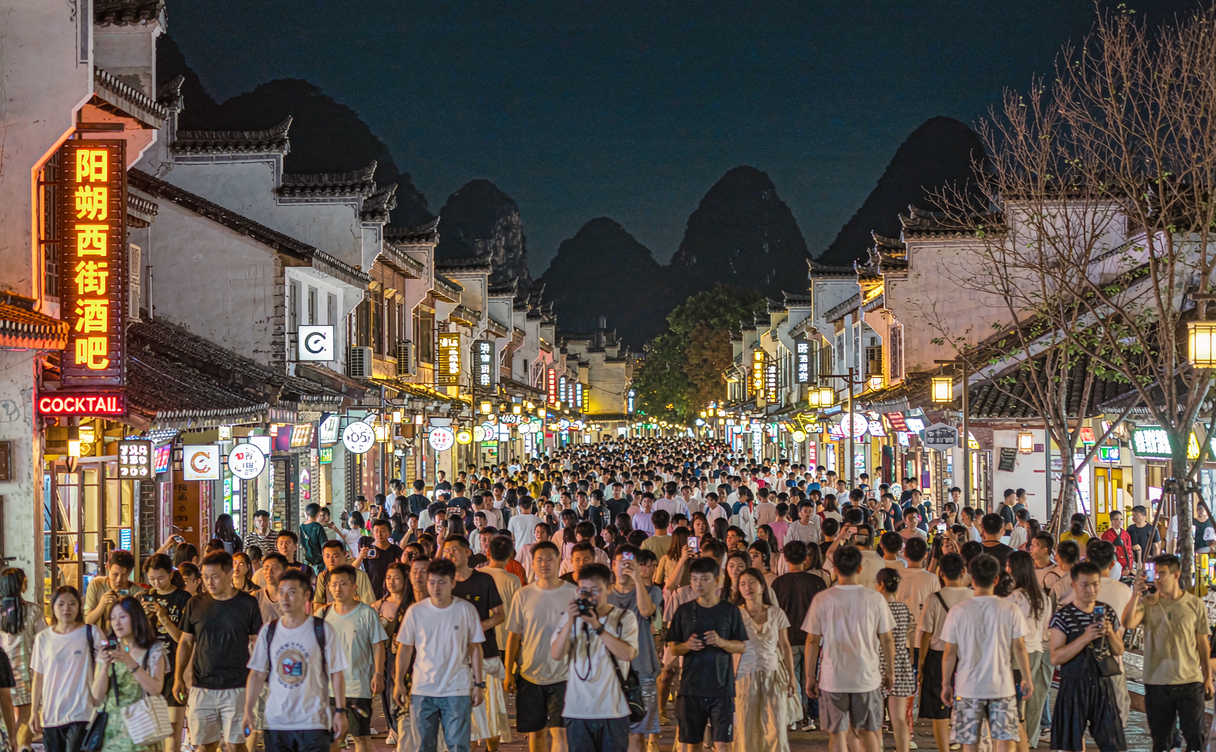 Yangshuo West Street nightlife - lit lane with lanterns and karst peaks