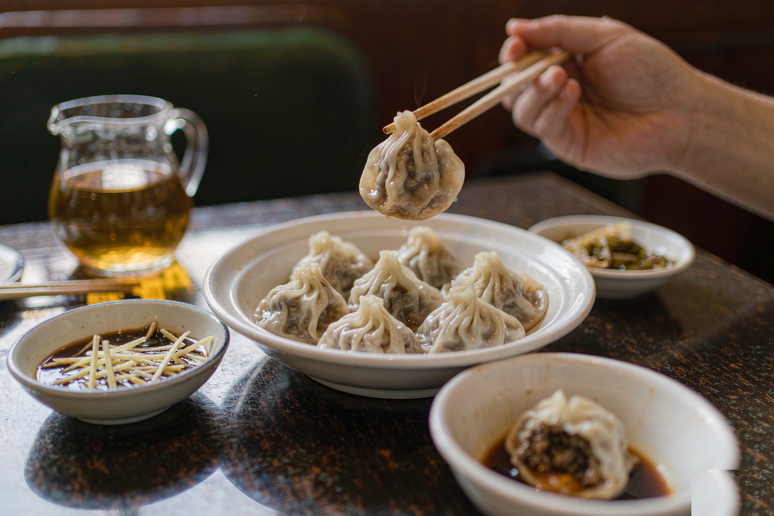 Xiaolongbao served with black vinegar and shredded ginger