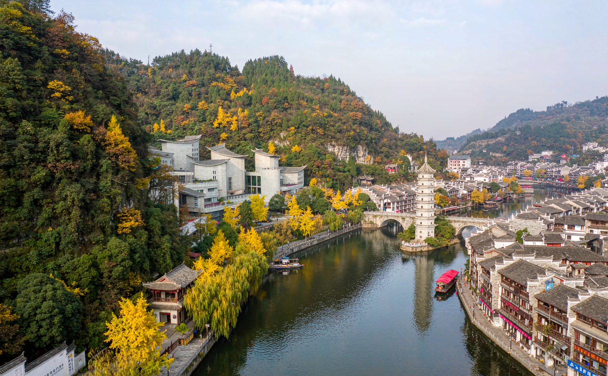 Riverside town with autumn forests in mainland China