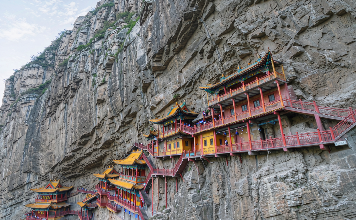 Wooden stairways of the Mati Temple Thirty-Three Day Cave climbing a red cliff
